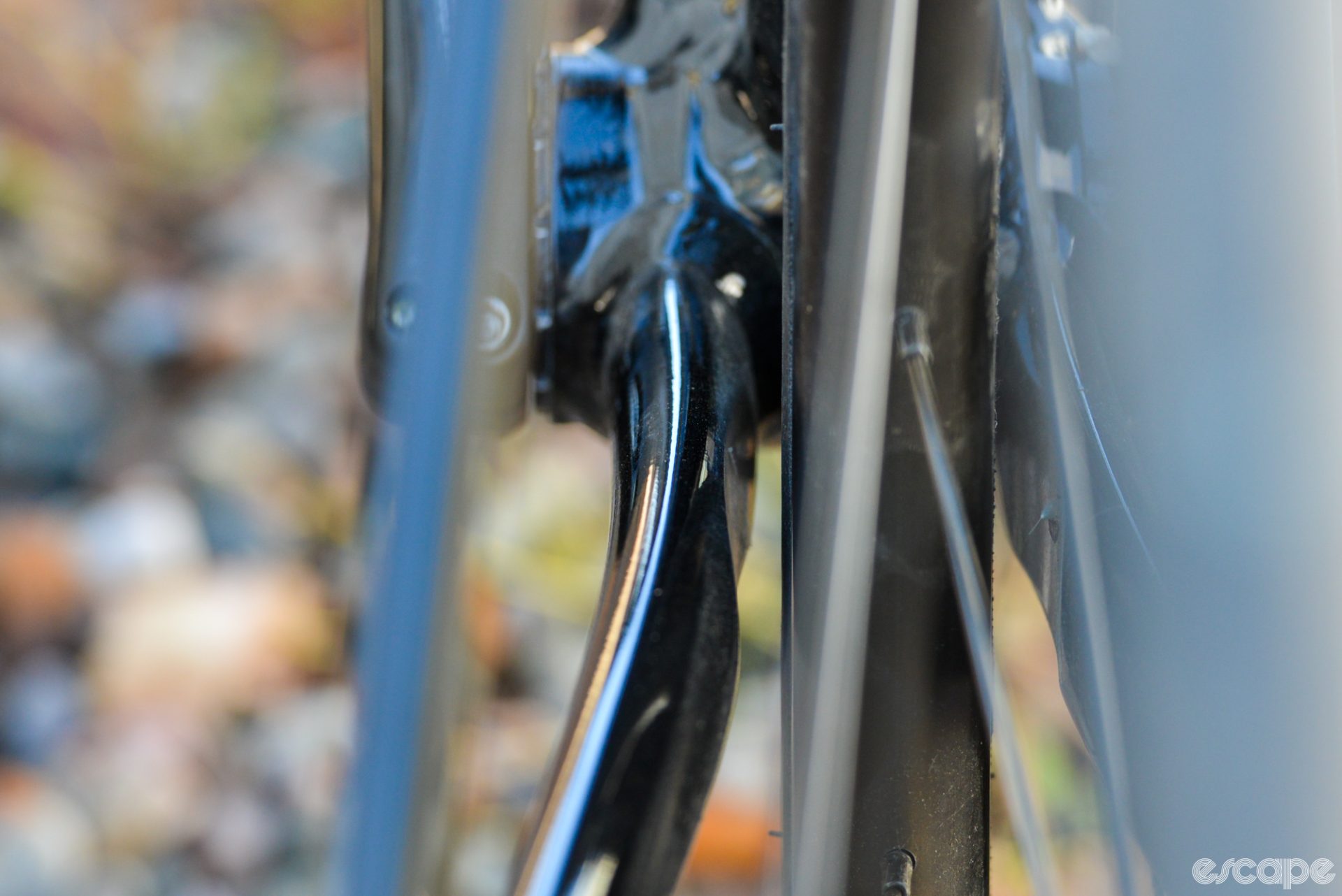 A closeup of rear tire clearance at the chainstay, showing a roughly 4.5 mm gap between the tire and inside wall of the stay.