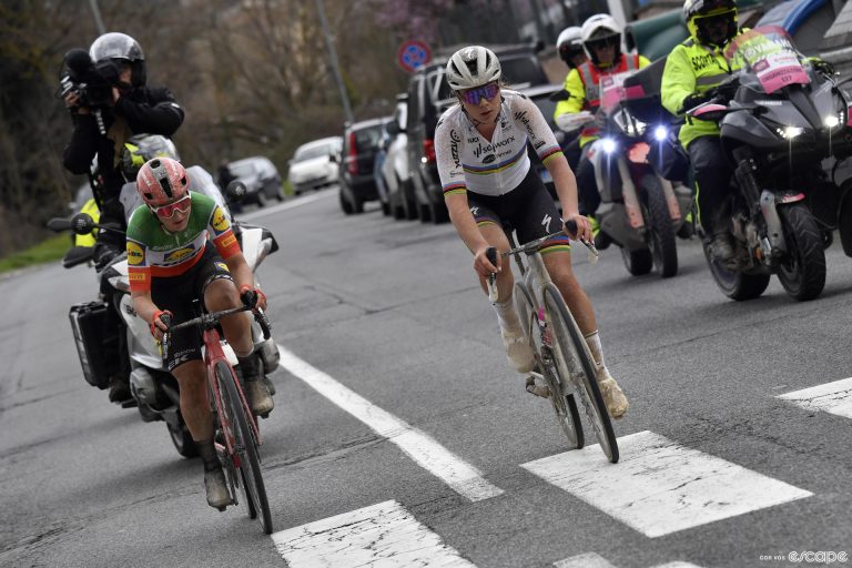 Elisa Longo Borghini and Lotte Kopecky ride side by side in a bike race.